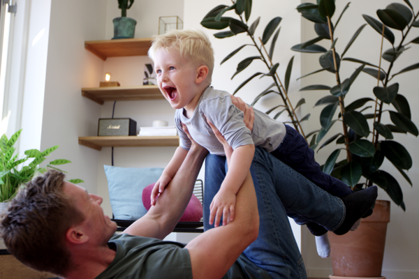 Dad playing with son.